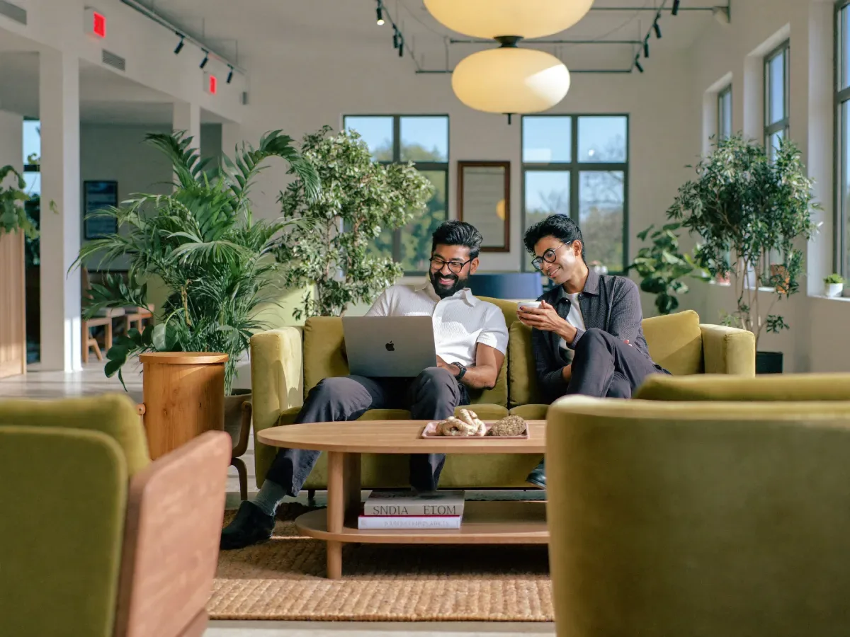 Members chatting in a sunny WeWork lounge